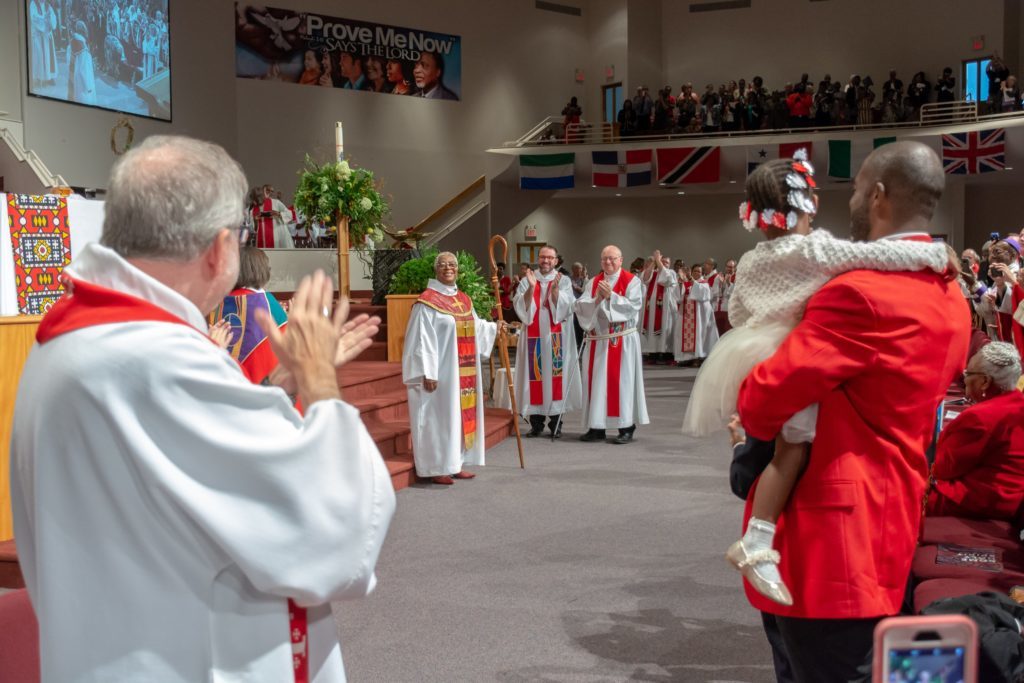 The congregation affirms Bishop Davenport after she received the signs of office — a cross and crozier.